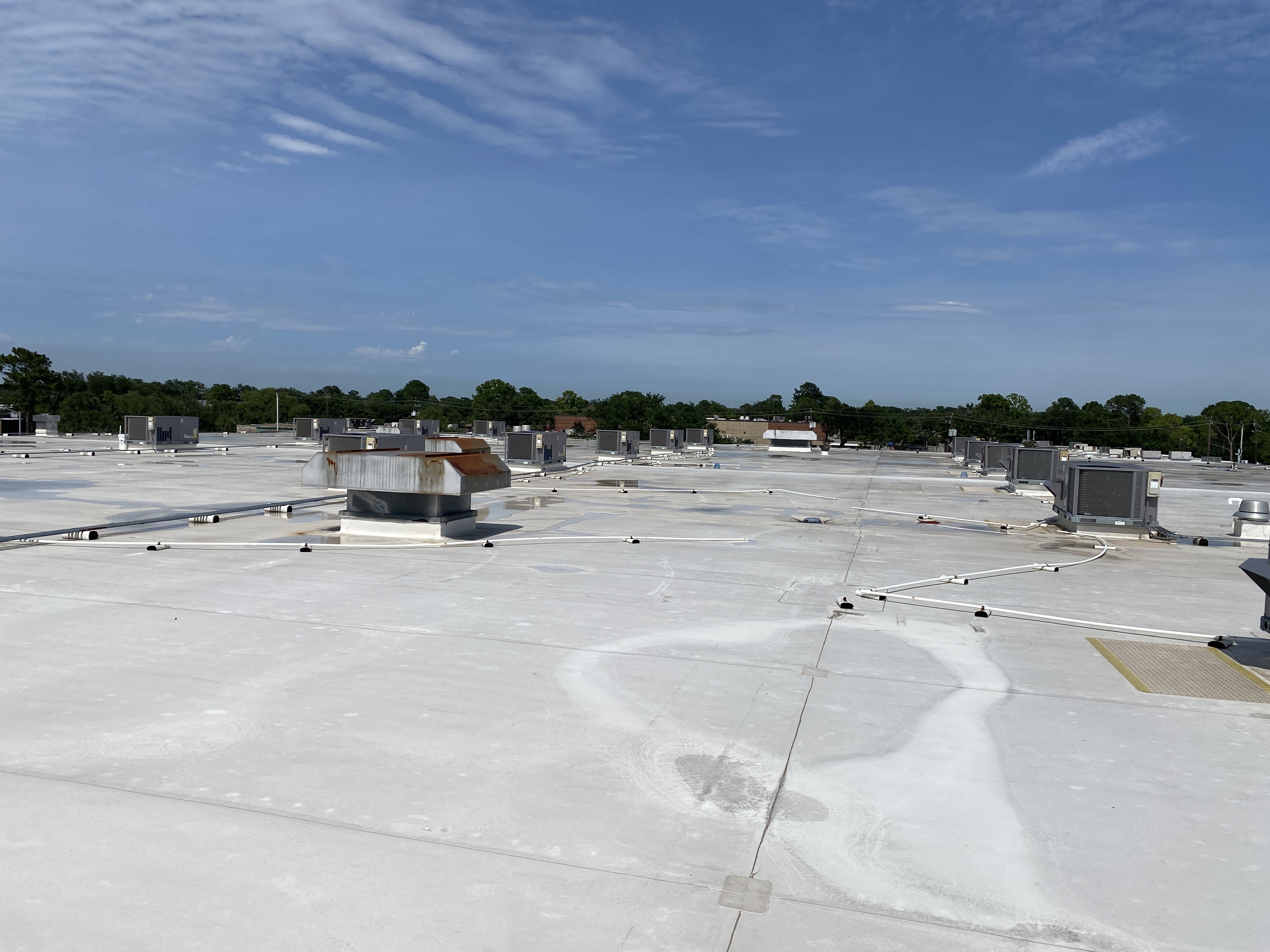 Large commercial flat roof with rooftop equipment
