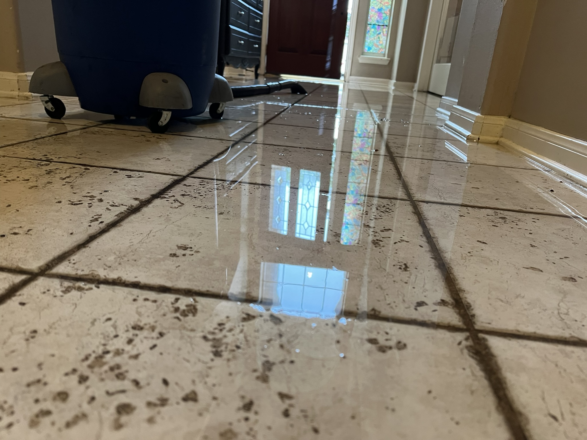 Standing water and extraction equipment documenting a water loss